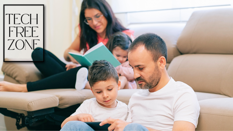 A mother reading a book with her toddler while the father and an older child use a smartphone, illustrating the contrast between screen time and offline engagement.